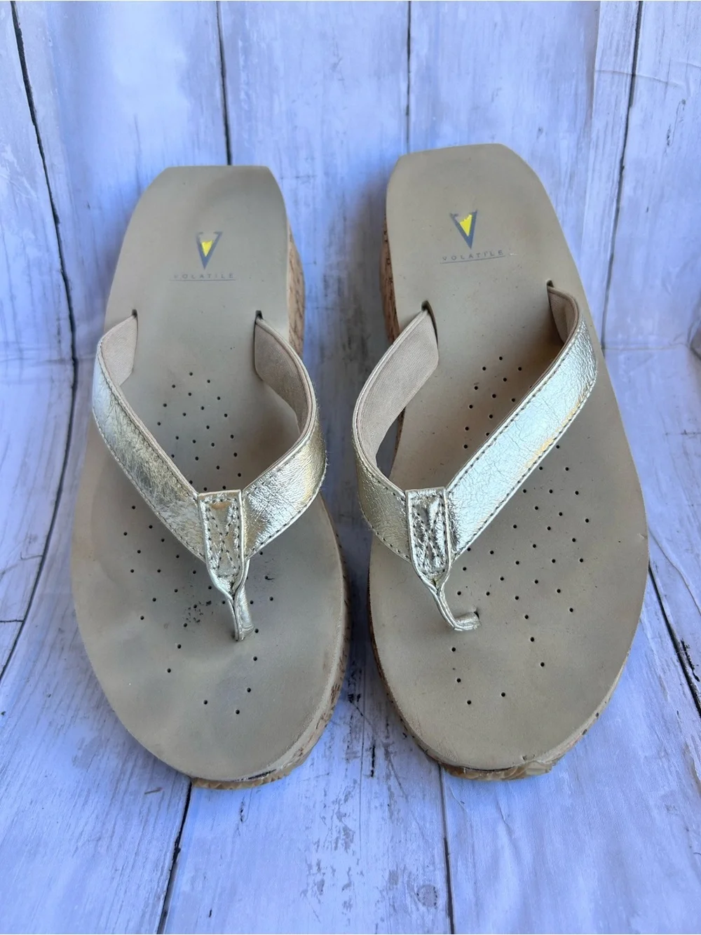 Volatile Gold thong wedge sandals with a cork platform,